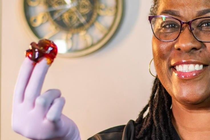 Instructor holding sugar paste at Bonaire Beauty Academy
